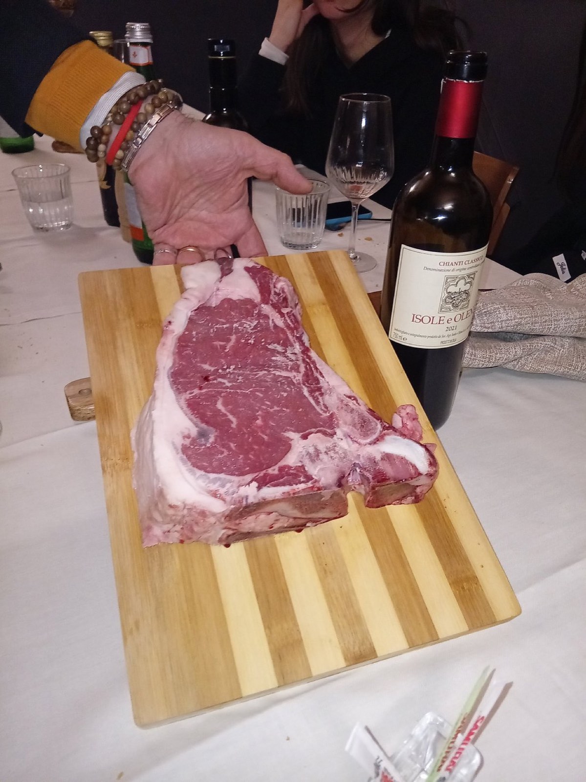 Fiorentina sul tagliere accanto a una bottiglia di Chianti Classico